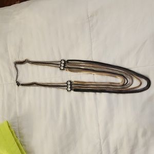 Silver, gold, and black necklace